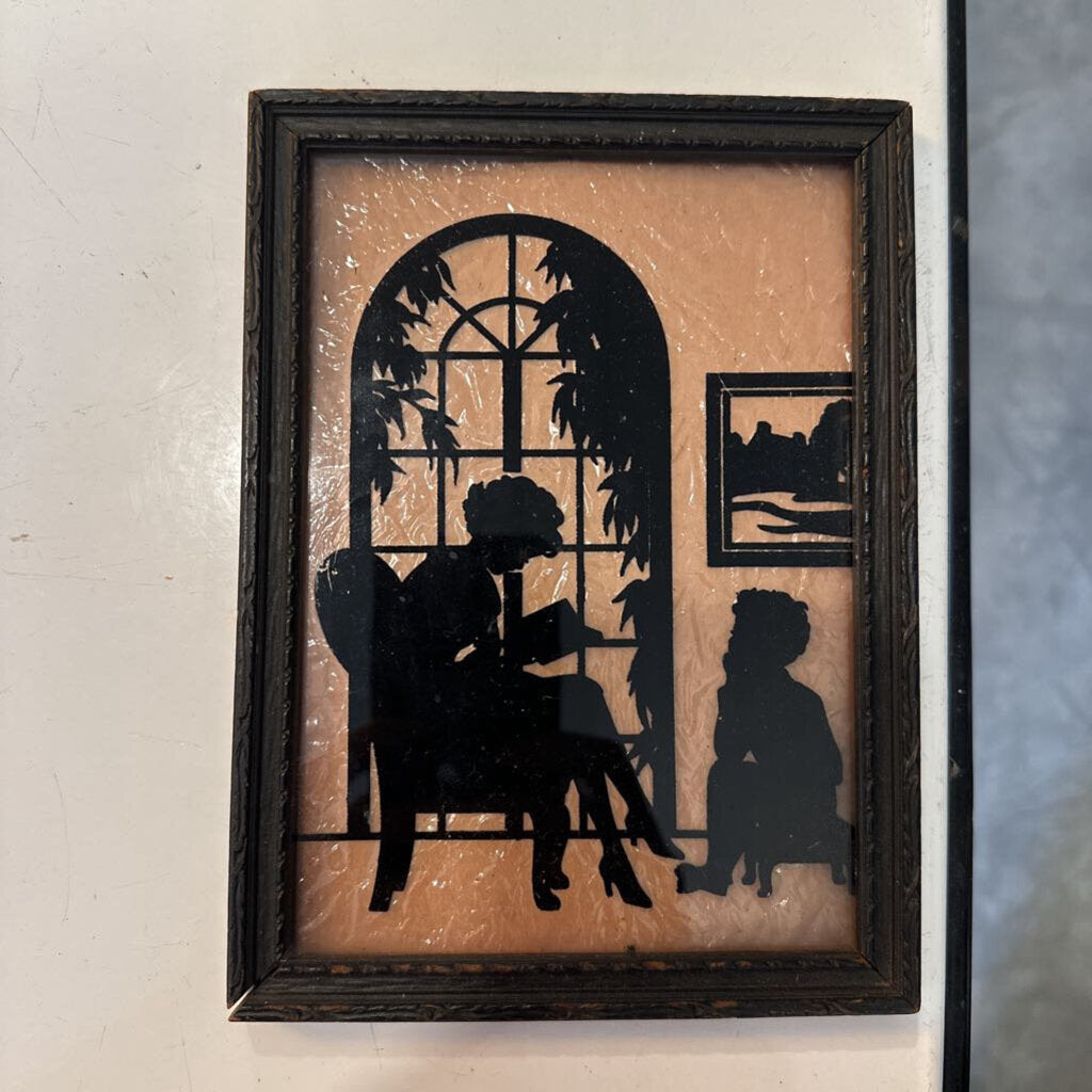 SILHOUETTE OF WOMAN READING TO A CHILD