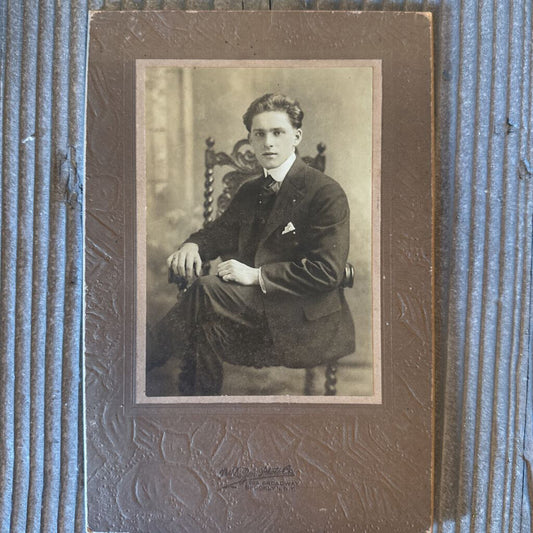 PHOTO CARD OF YOUNG MAN SEATED