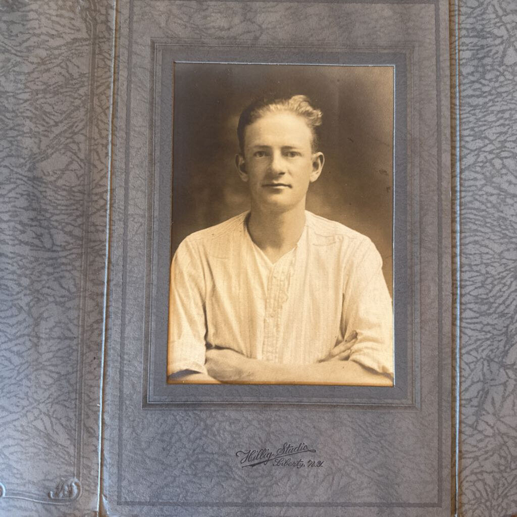 PHOTO CARD OF YOUNG MAN SEATED