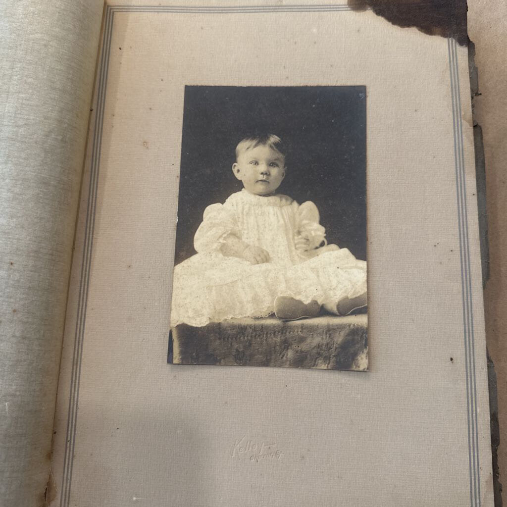 PHOTO OF BABY IN WHITE DRESS