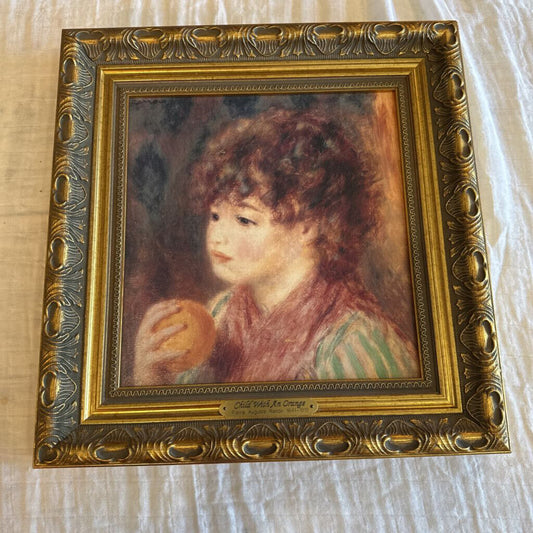 CHILD WITH AN ORANGE BY PIERRE AUGUSTE RENOIR