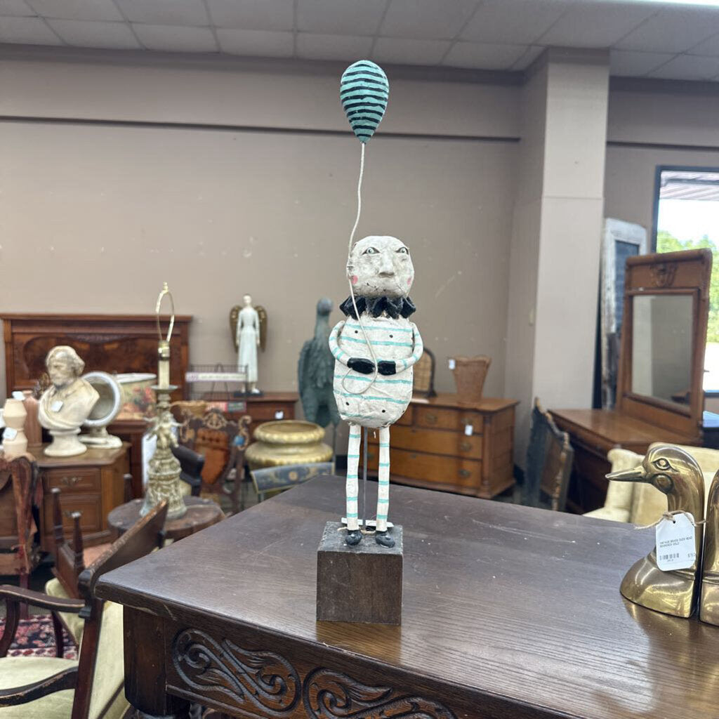 PAPER MACHE SCULPTURE OF CLOWN HOLDING A BALLOON
